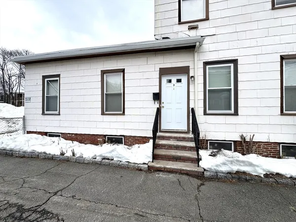 a view of a house with wooden fence