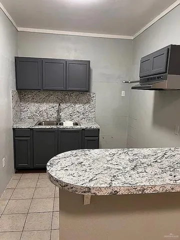 a kitchen with a stove and a refrigerator