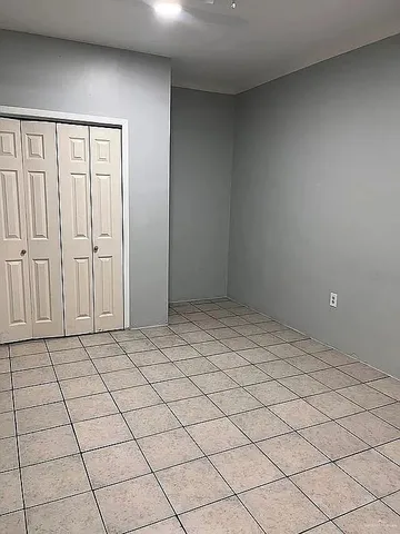 a view of an empty room and wooden floor