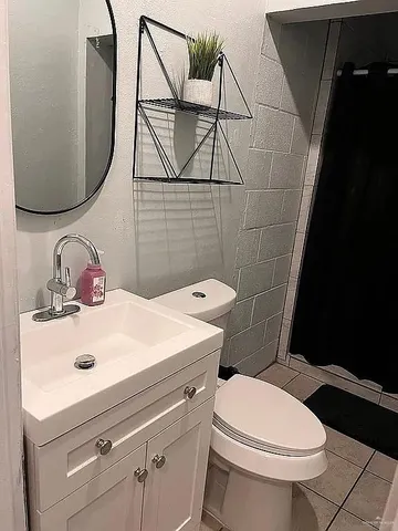 a bathroom with a sink toilet and mirror