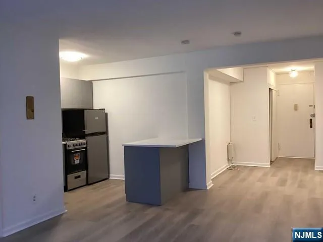 a kitchen with stainless steel appliances a refrigerator and a stove top oven