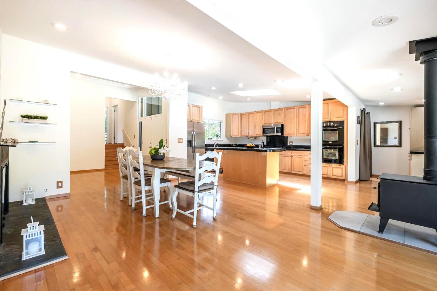 3386 Haas Drive Aptos, CA 95003 - Photo 13 of 56 a dining room with furniture a kitchen view and chandelier