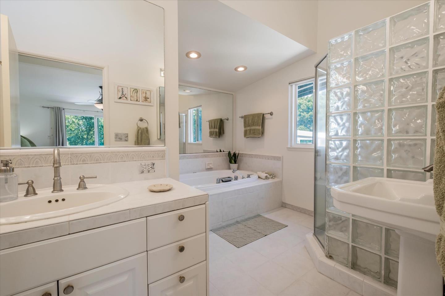 3386 Haas Drive Aptos, CA 95003 - Photo 22 of 56 a bathroom with a double vanity sink a toilet a mirror and shower