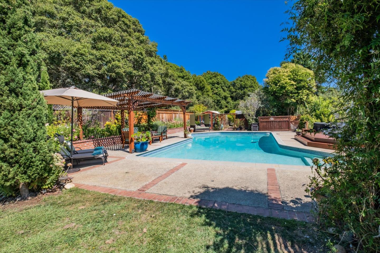 3386 Haas Drive Aptos, CA 95003 - Photo 5 of 56 a view of a patio with table and chairs under an umbrella
