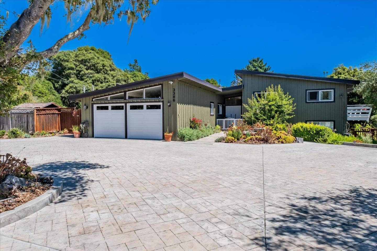 3386 Haas Drive Aptos, CA 95003 - Photo 6 of 56 a front view of a house with a yard and a garage