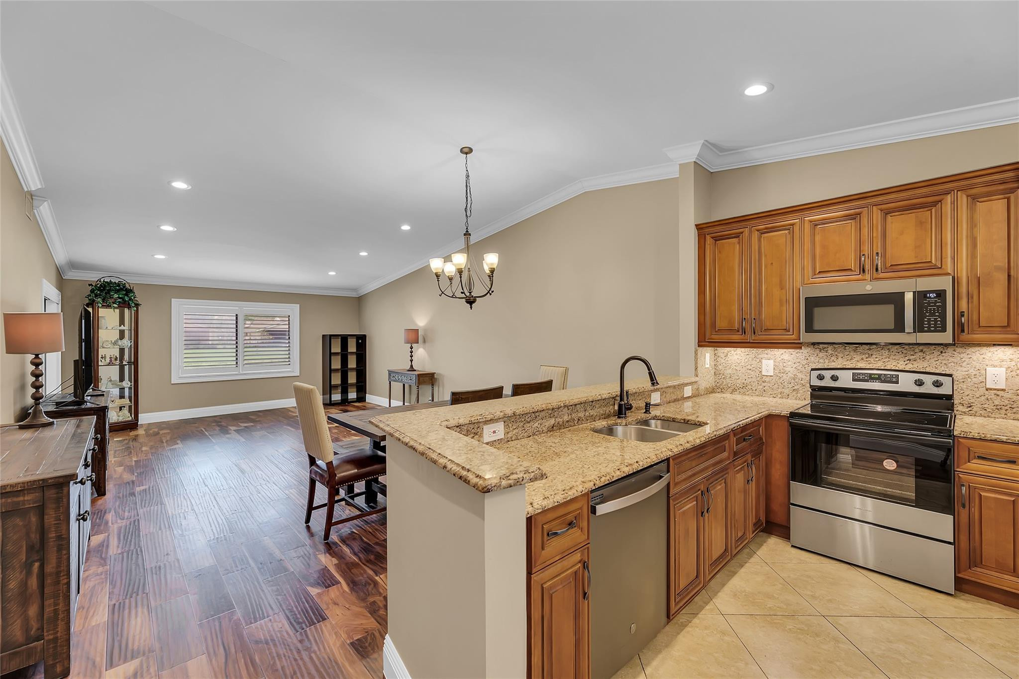 8306 Springlake Drive, Unit C Boca Raton, FL 33496 - Photo 18 of 44 a kitchen that has a lot of cabinets a sink and appliances