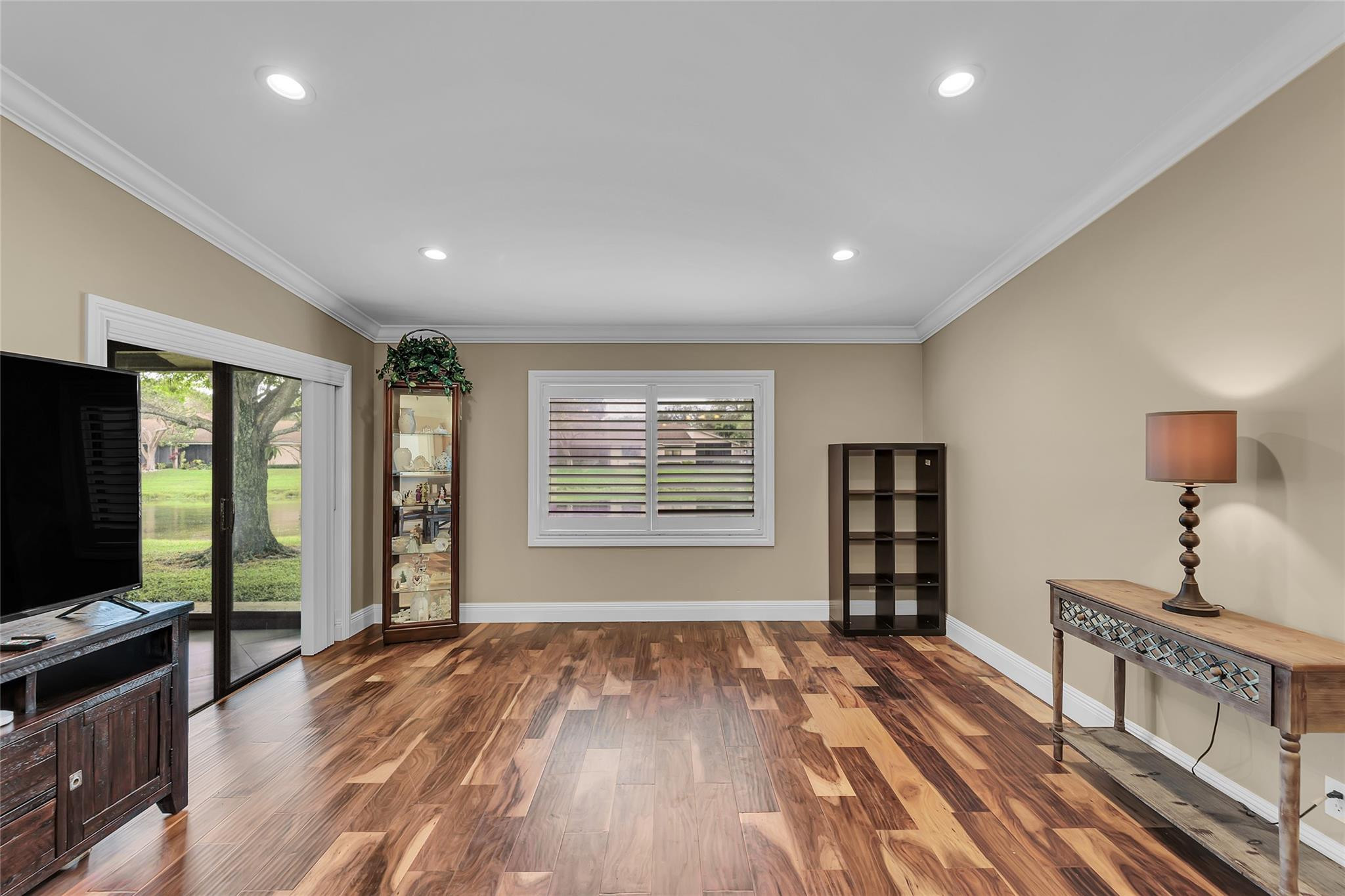 8306 Springlake Drive, Unit C Boca Raton, FL 33496 - Photo 5 of 44 a view of an empty room with wooden floor and a window