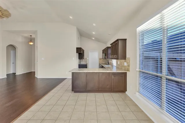 a kitchen with stainless steel appliances a refrigerator and a stove top oven
