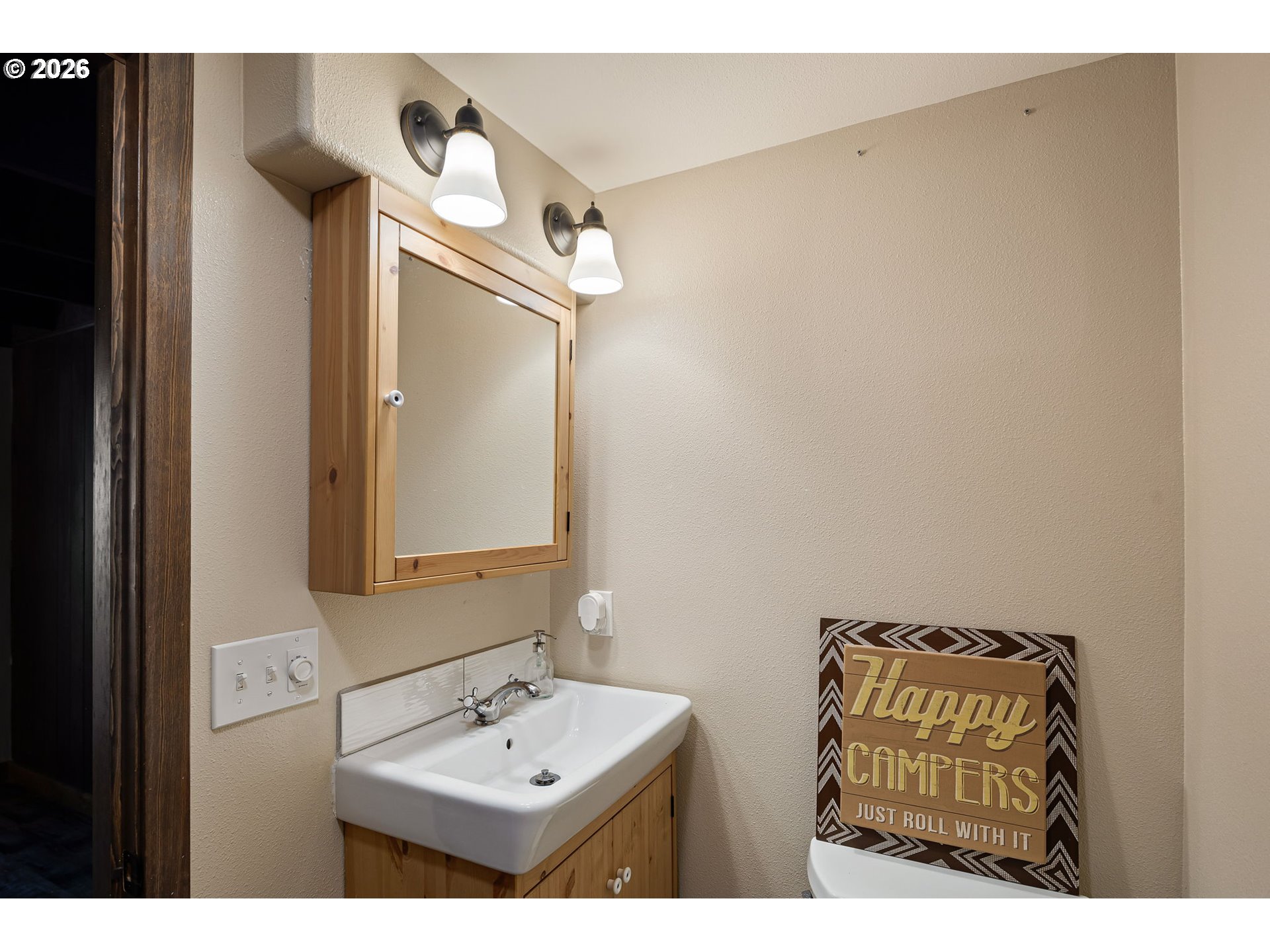 88481 1st Avenue Florence, OR 97439 - Photo 27 of 43 a bathroom with a sink a mirror and vanity