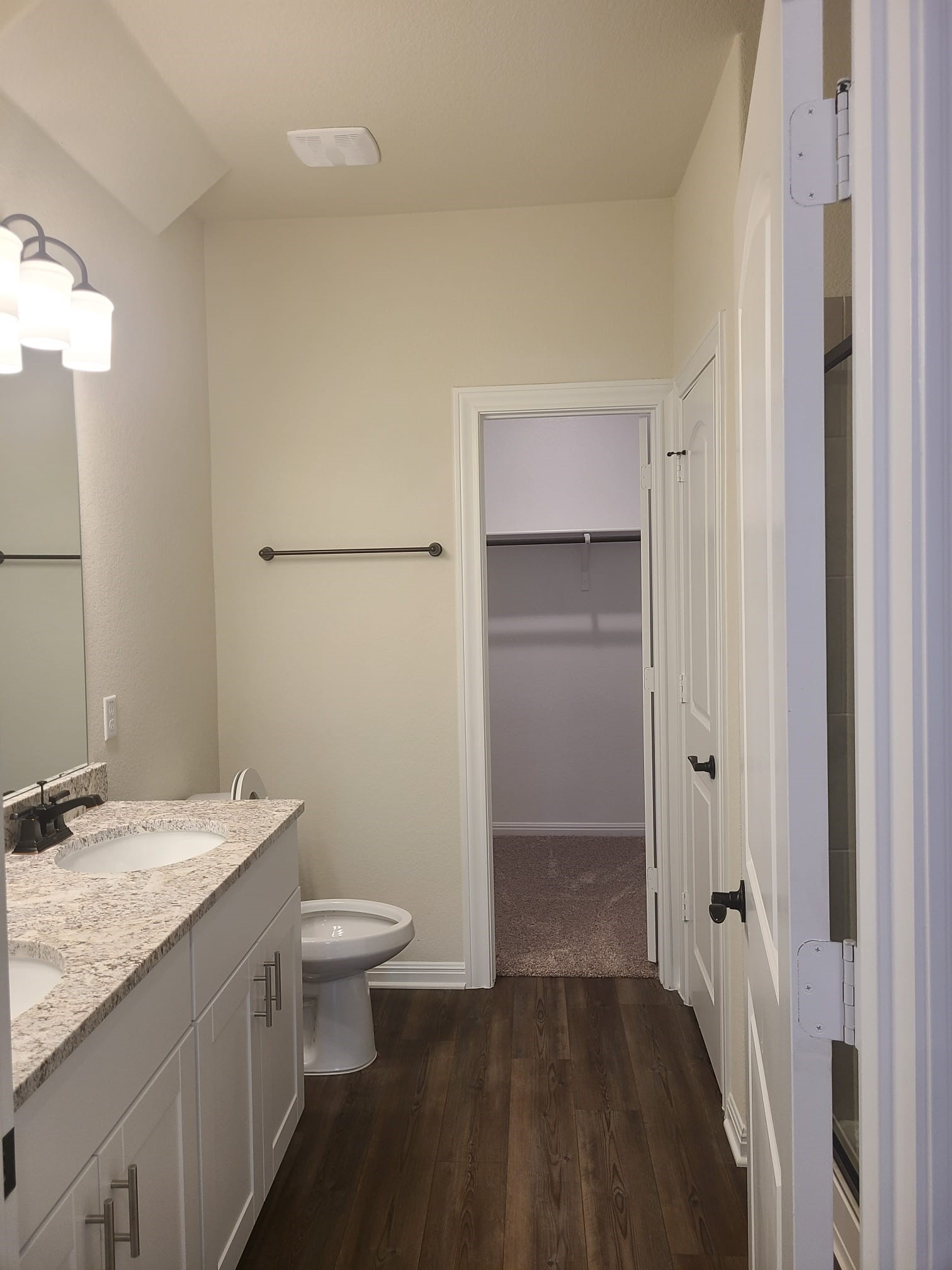 32 Pacific Loon Street Leander, TX 78641 - Photo 11 of 34 a bathroom with a granite countertop sink a toilet and shower