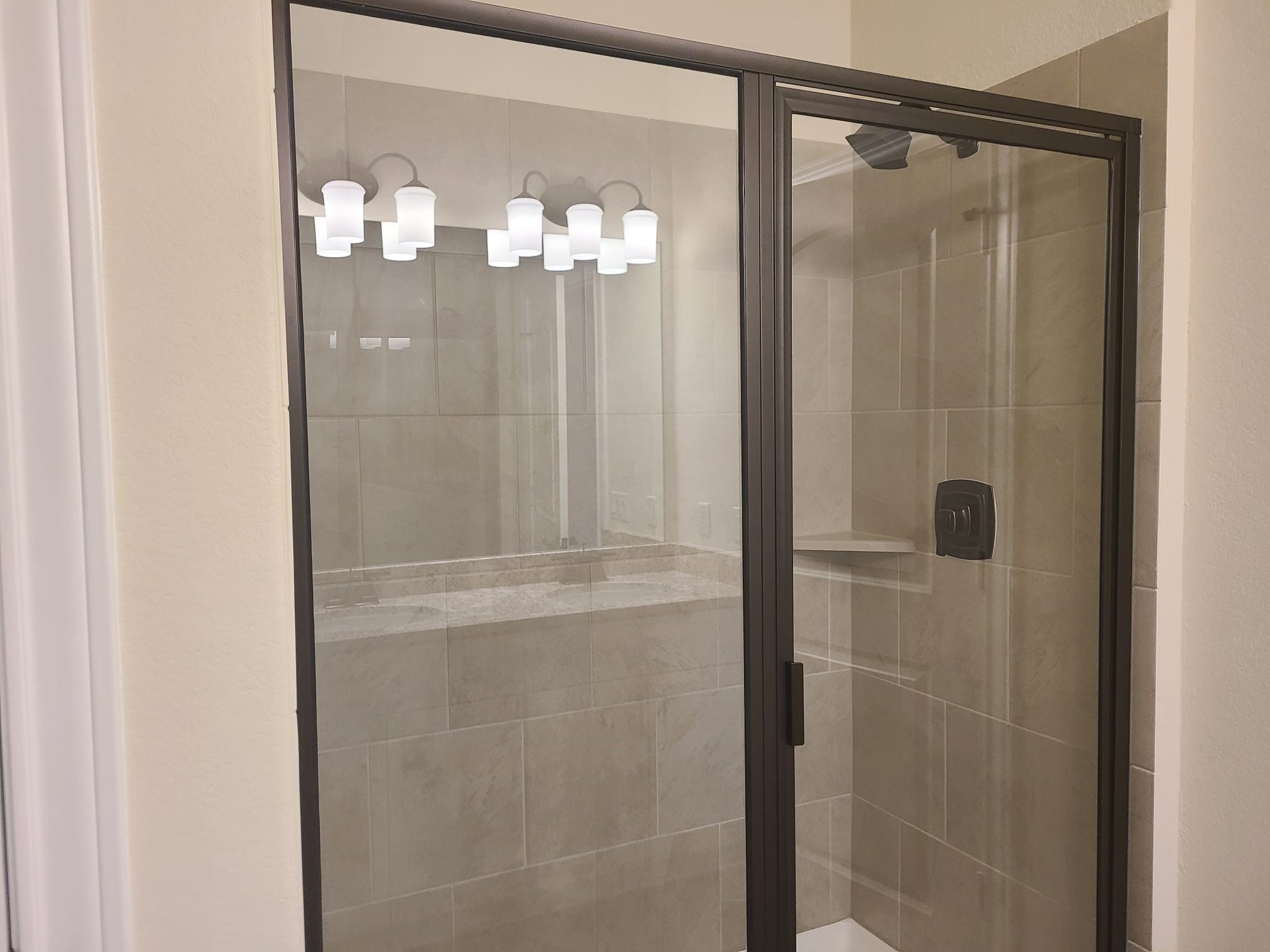 32 Pacific Loon Street Leander, TX 78641 - Photo 13 of 34 a bathroom with a glass shower door and a shower
