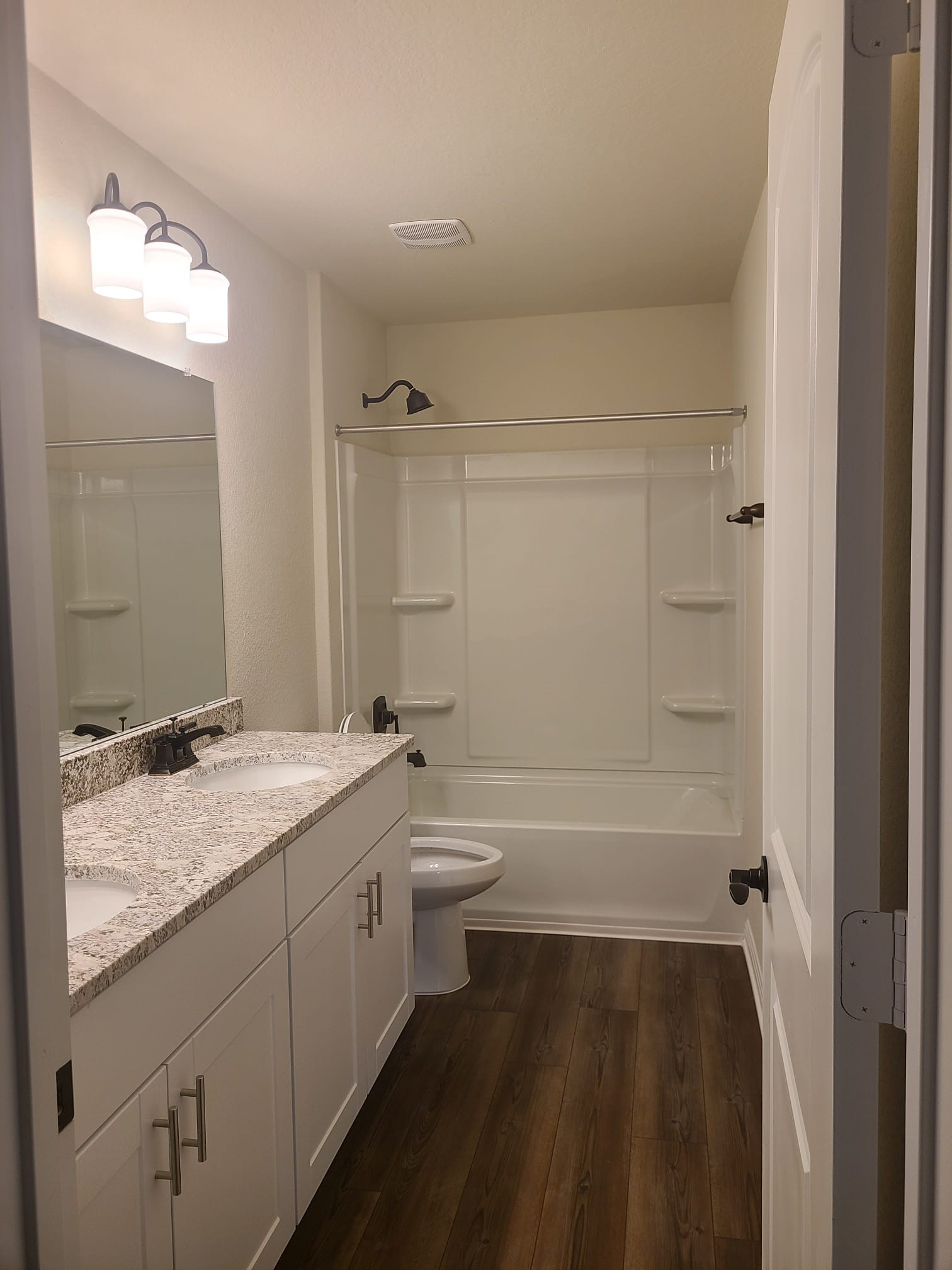32 Pacific Loon Street Leander, TX 78641 - Photo 19 of 34 a bathroom with a granite countertop sink toilet and shower