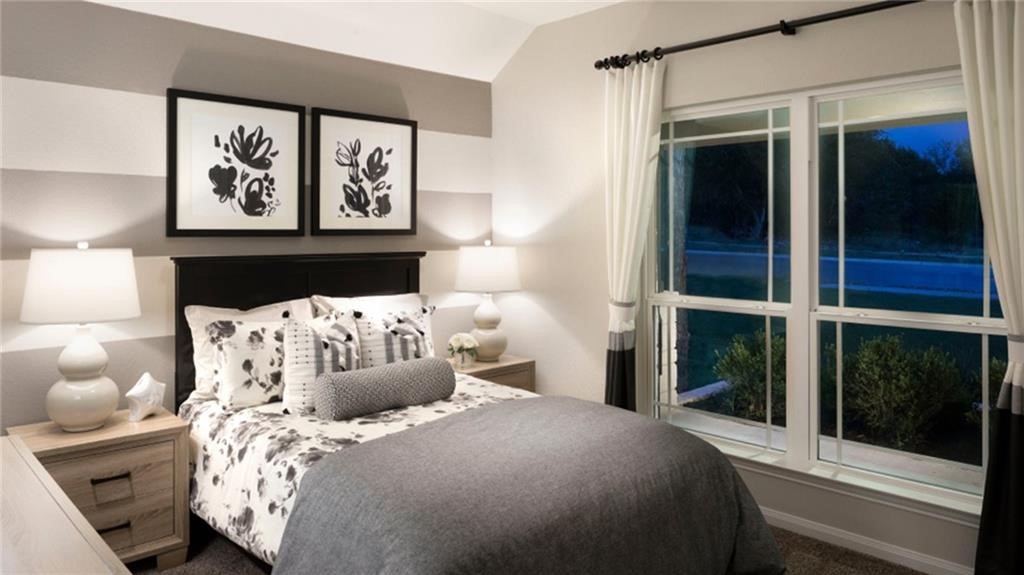 32 Pacific Loon Street Leander, TX 78641 - Photo 22 of 34 a bedroom with a bed and a painting on the wall