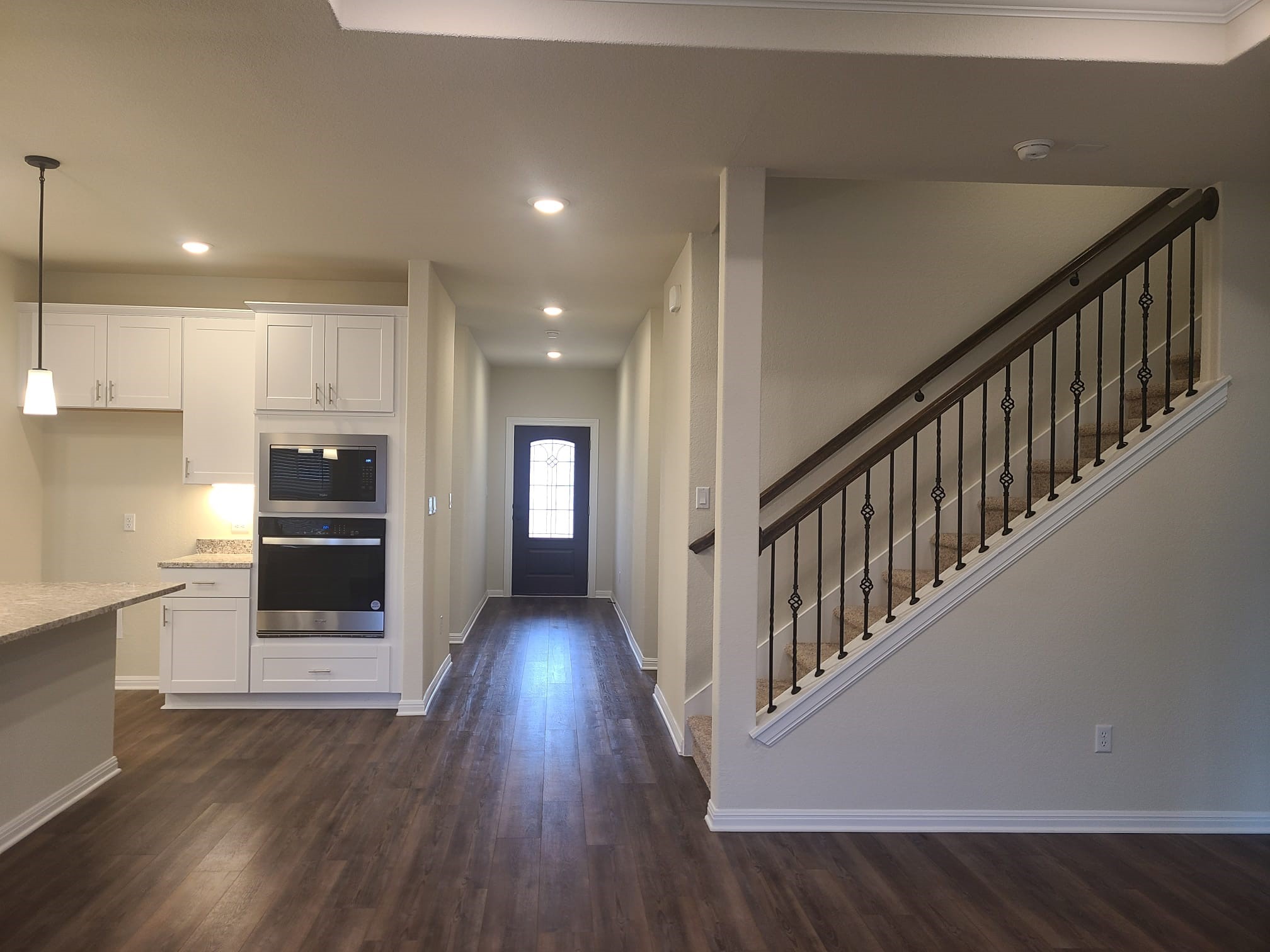 32 Pacific Loon Street Leander, TX 78641 - Photo 3 of 34 a view of a hallway with wooden floor and staircase