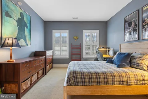 a bedroom with a bed and closet with mirror