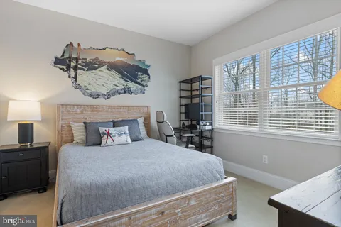 a bedroom with a bed lamp and a flat screen tv