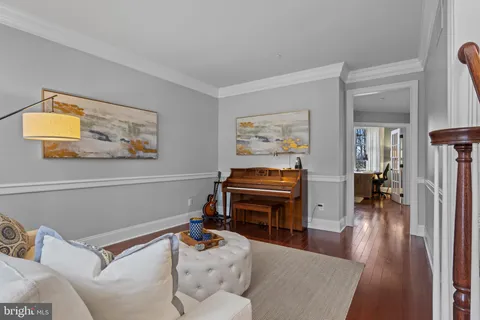 a living room with furniture and a piano