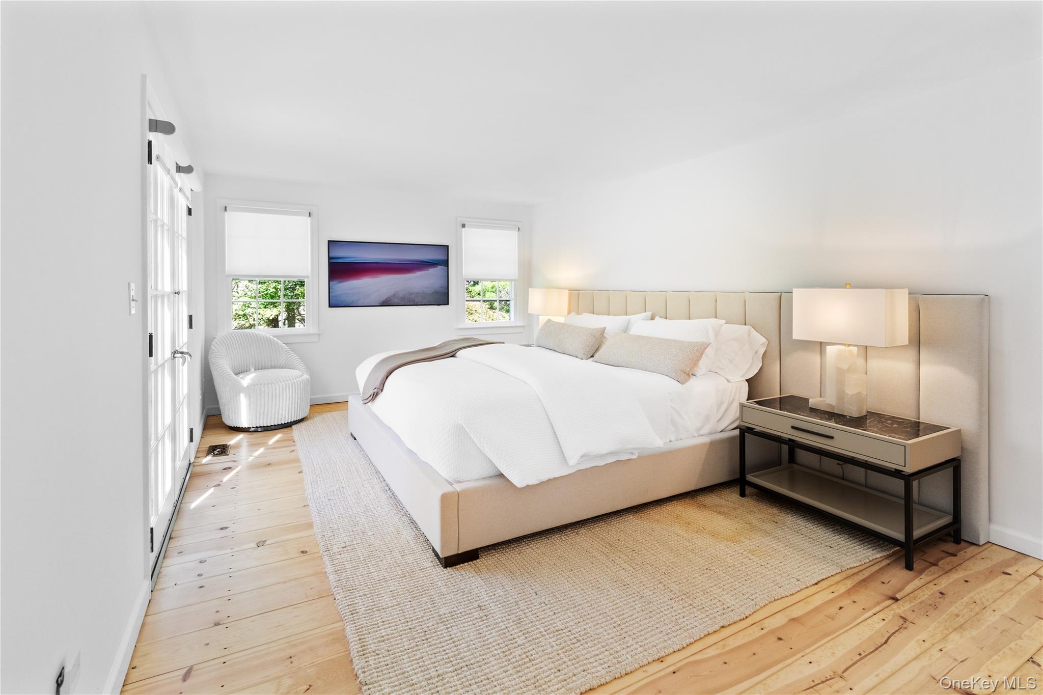 197 Hog Creek Road East Hampton, NY 11937 - Photo 12 of 17 a bedroom with a bed and a couch