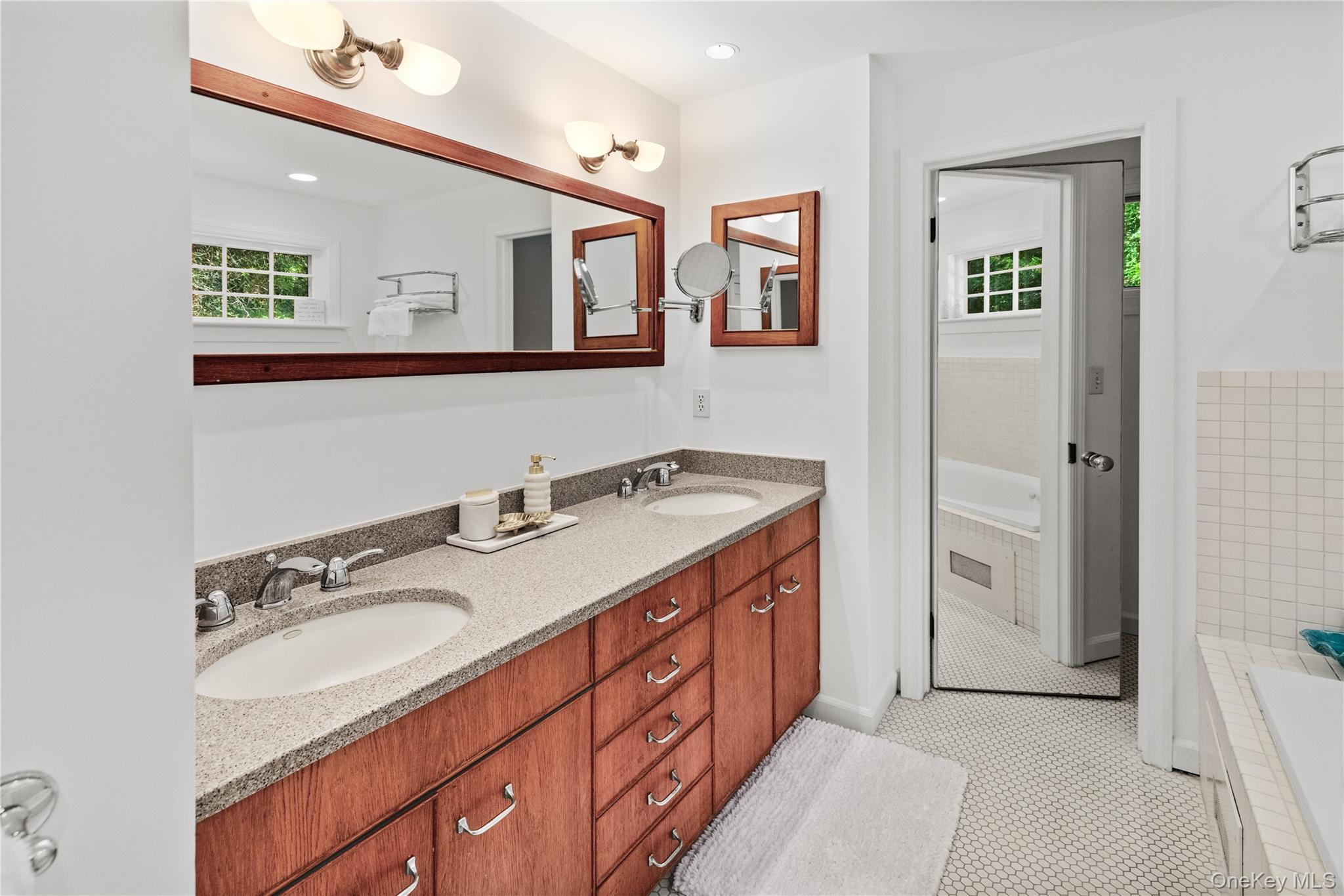 197 Hog Creek Road East Hampton, NY 11937 - Photo 13 of 17 a spacious bathroom with a double vanity sink and a mirror