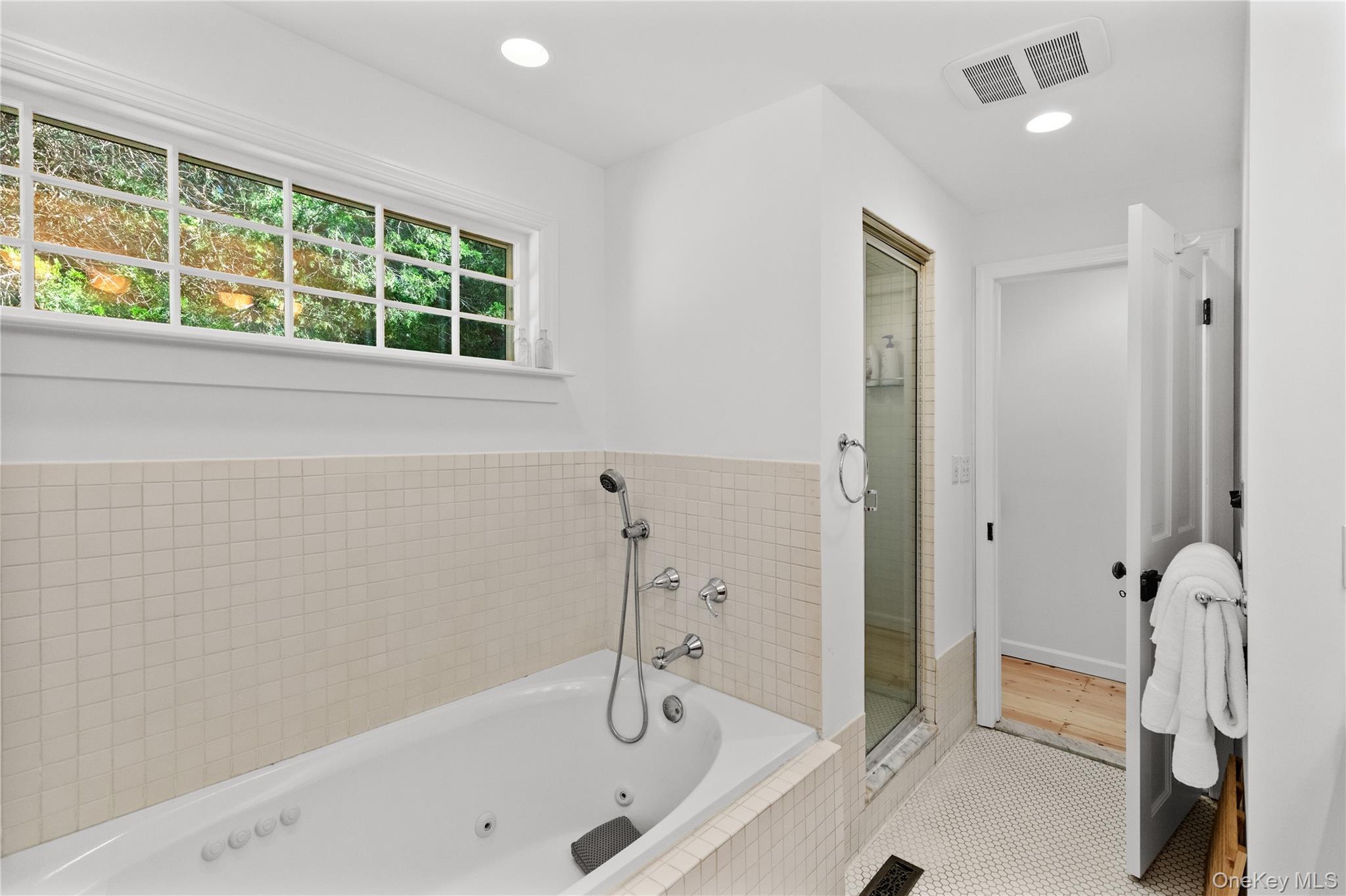 197 Hog Creek Road East Hampton, NY 11937 - Photo 14 of 17 a bathroom with a tub and a shower
