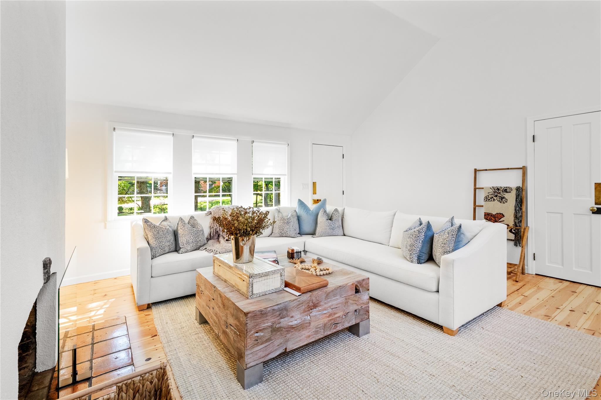 197 Hog Creek Road East Hampton, NY 11937 - Photo 4 of 17 a living room with furniture white walls and a large window