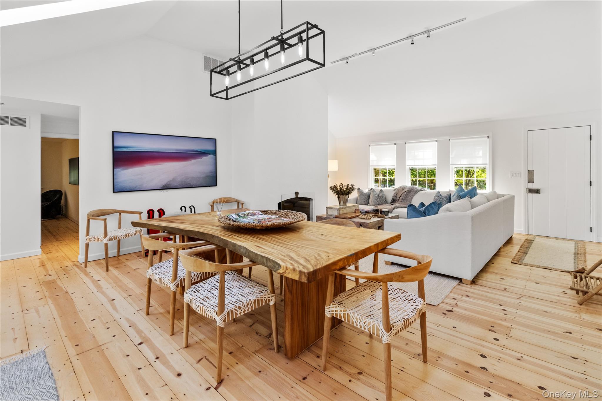 197 Hog Creek Road East Hampton, NY 11937 - Photo 6 of 17 a living room with a table chairs and a refrigerator