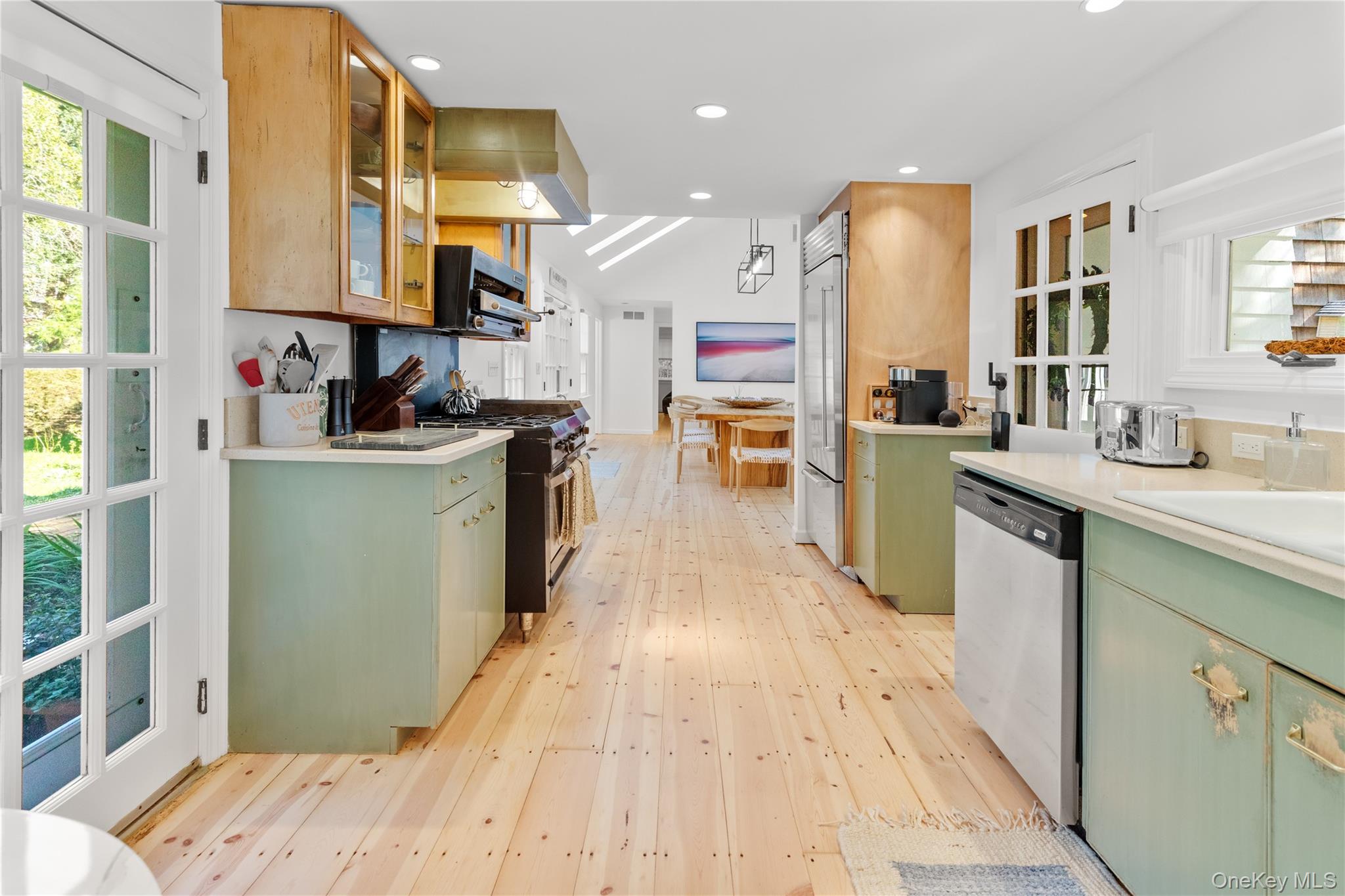 197 Hog Creek Road East Hampton, NY 11937 - Photo 9 of 17 a kitchen with stainless steel appliances kitchen island granite countertop a refrigerator a stove top oven and a sink