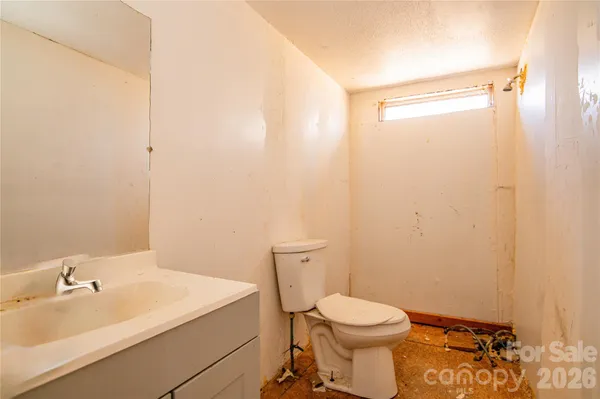 a white toilet sitting next to a bathroom sink