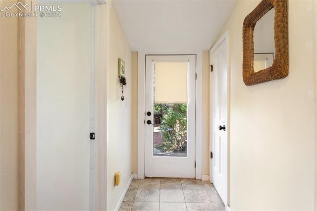 918 High Road Manitou Springs, CO 80829 - Photo 3 of 34 Doorway to outside featuring light tile patterned floors