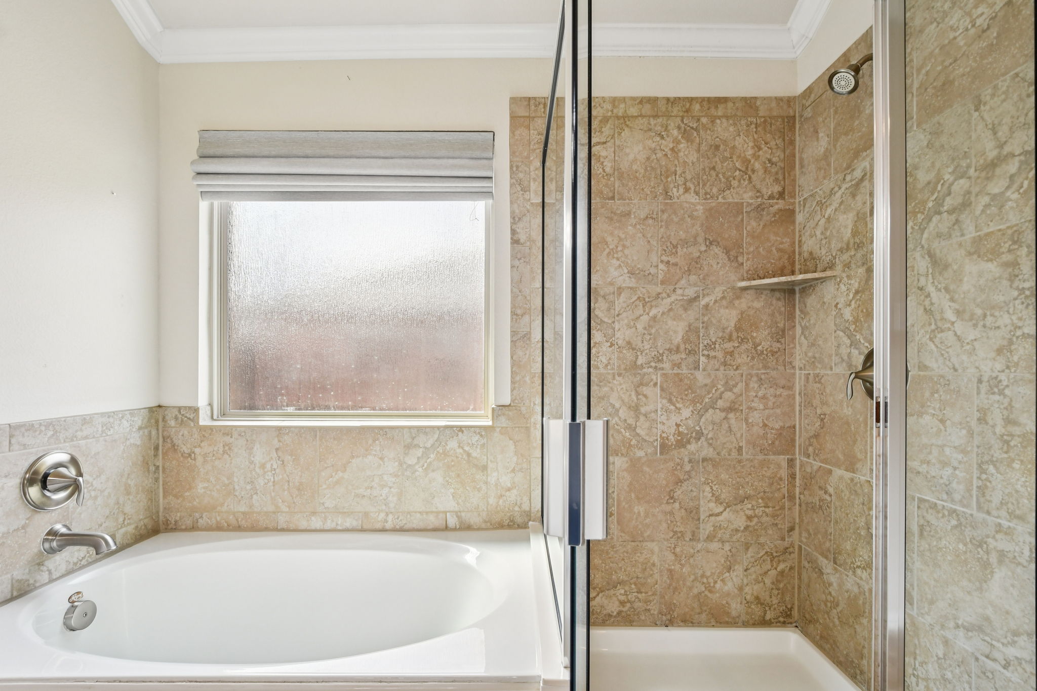 329 Evening Star Kyle, TX 78640 - Photo 20 of 30 Best of both worlds: a soaking tub for slow evenings and a separate walk-in shower when you’re on the go.