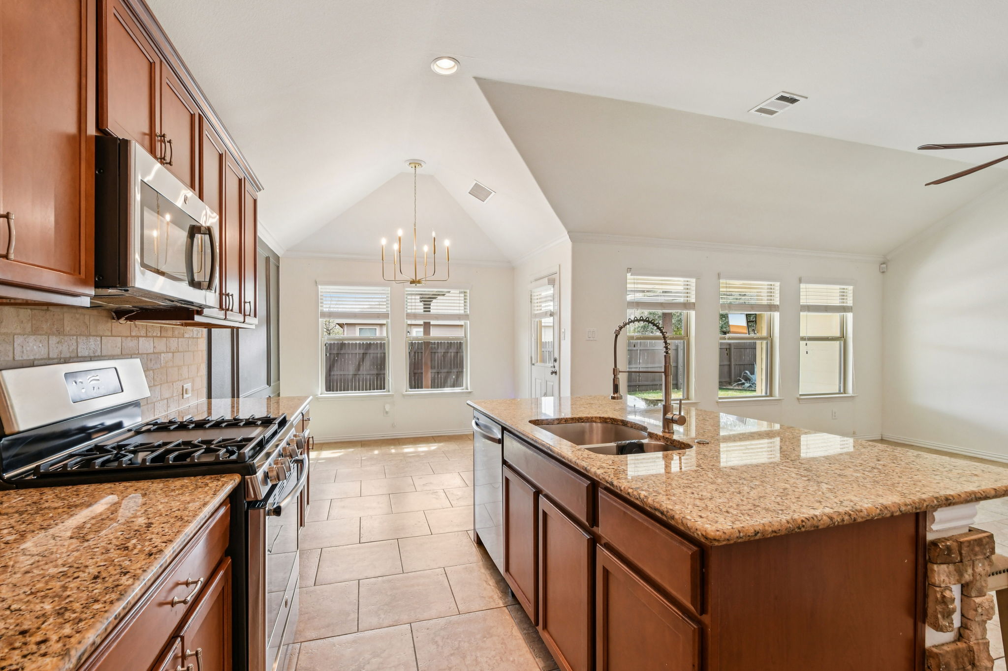 329 Evening Star Kyle, TX 78640 - Photo 3 of 30 The kitchen sits at the heart of
the living area with granite
countertops, a generous island,
and SS appliances.