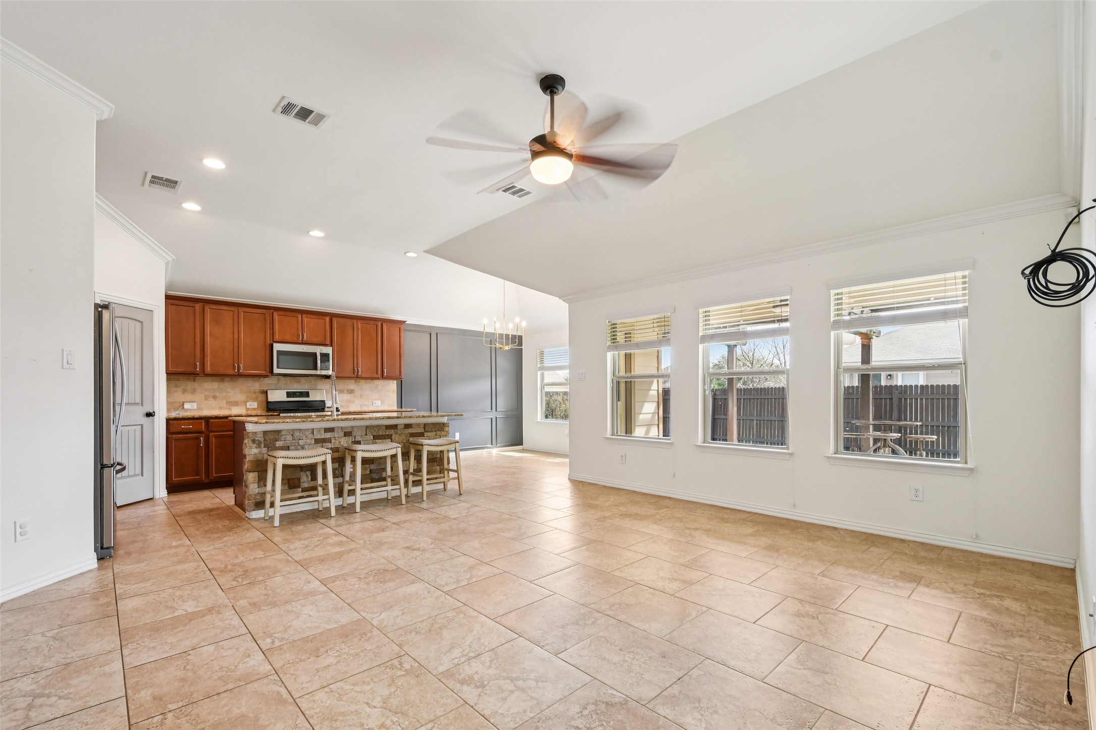 329 Evening Star Kyle, TX 78640 - Photo 8 of 30 Open, bright, and set up for real life. Living flows right into the kitchen and dining, so whoever’s cooking is still in the mix.