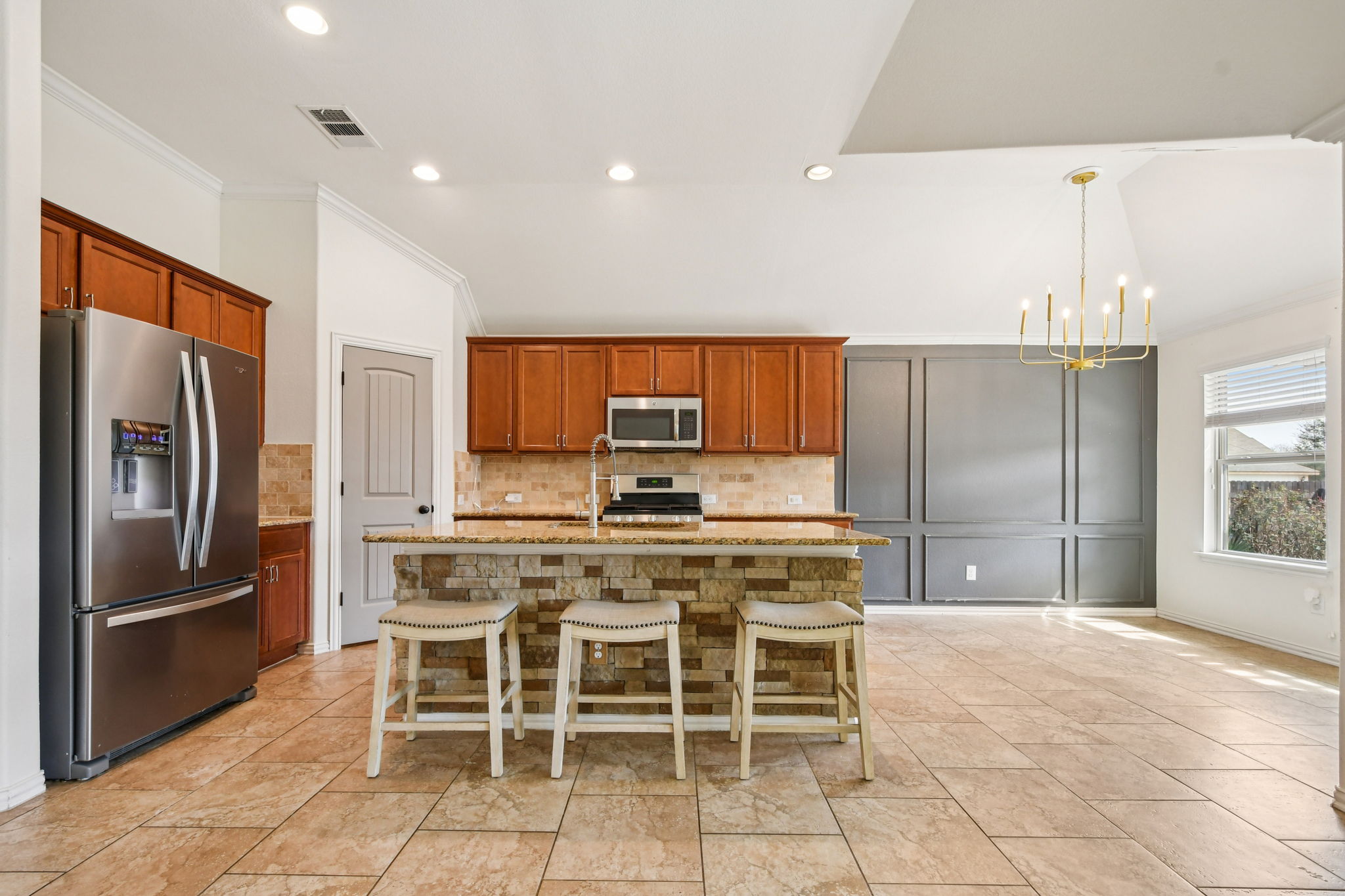 329 Evening Star Kyle, TX 78640 - Photo 9 of 30 Kitchen command center. A granite island with bar seating, ready for coffee, homework, and “snack decisions.”