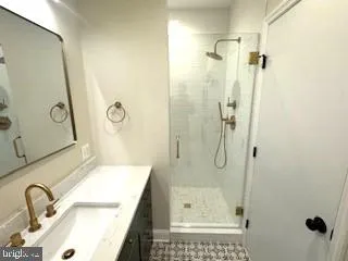 a bathroom with a granite countertop shower mirror and a sink