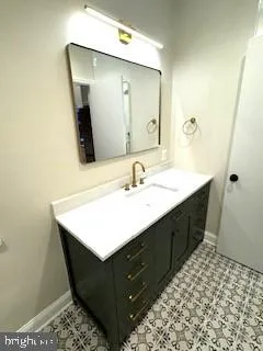 a bathroom with a sink vanity and mirror