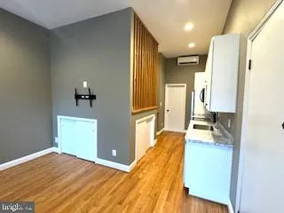 a bedroom with a bed and a view of living room