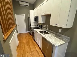 a kitchen with a sink stove and cabinets
