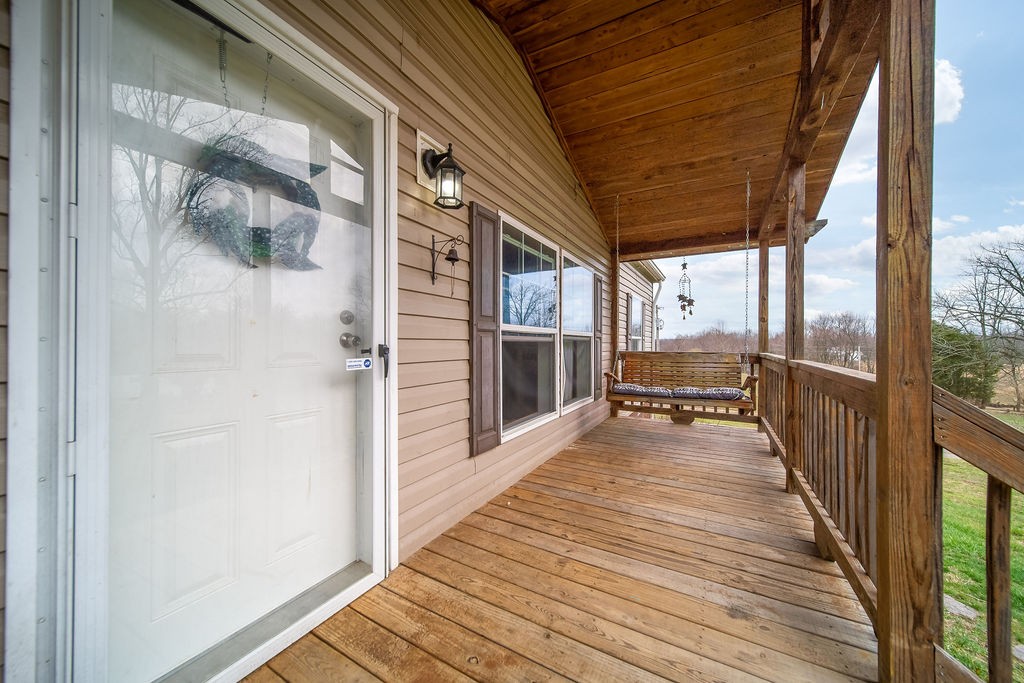 127 Ernest Cates Road Bethpage, TN 37022 - Photo 4 of 26 a view of a balcony with wooden floor and floor to ceiling window