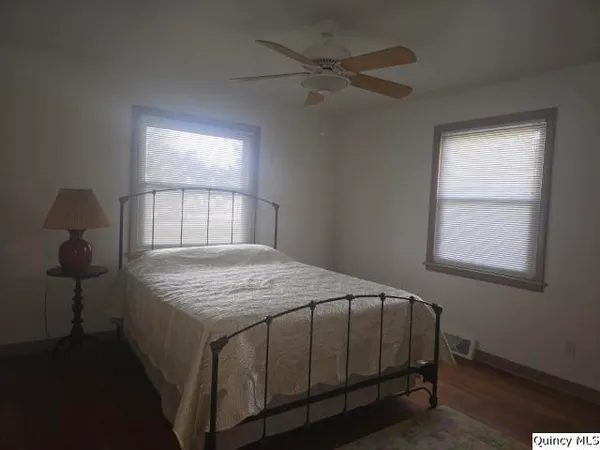 an empty room with a window and closet