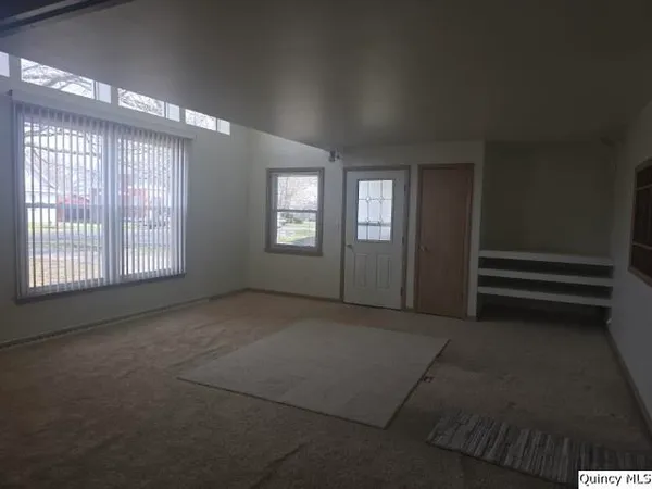 a view of an empty room with windows