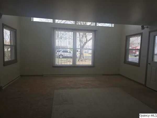 an empty room with a empty space and windows