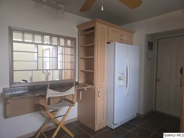 a kitchen with a stove sink and cabinets