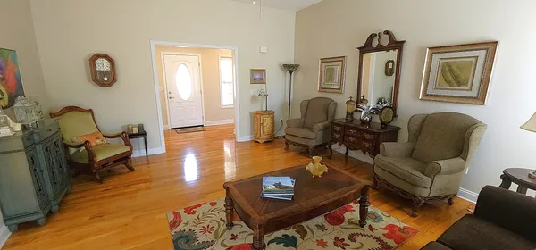 a living room with furniture and wooden floor