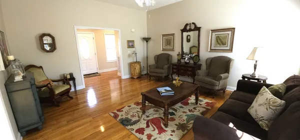a living room with furniture chess table and a window