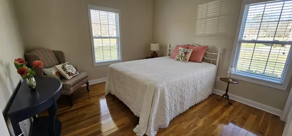 a bedroom with a bed and windows