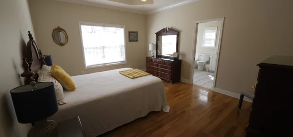 a bedroom with bed and window