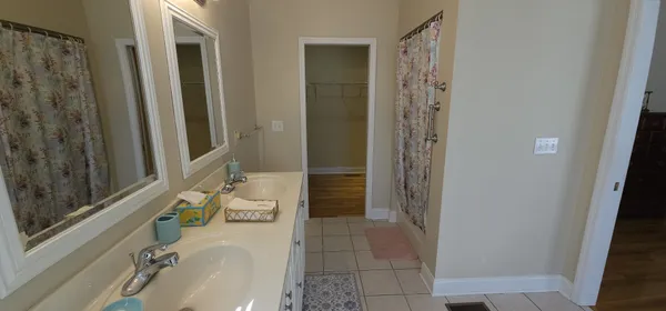 a bathroom with a tub shower and sink