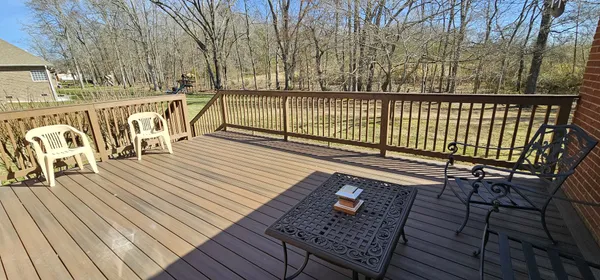 a view of a roof deck with wooden floor and fence