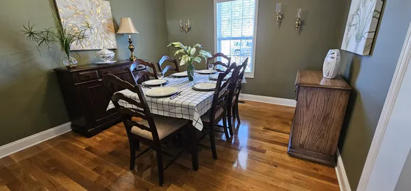 a view of a dining room with furniture and wooden floor