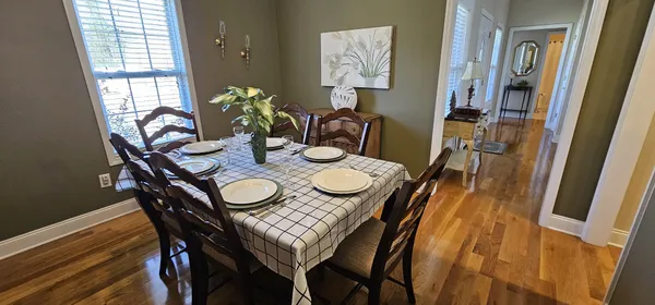 a view of a dining room with furniture and wooden floor